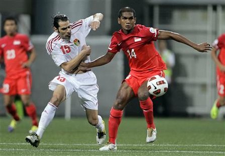 Singapore's Hariss Harun and Jordan's Shadi Abu Hashhash fight for the ball during their 2014 FIFA World Cup qualifying soccer match in Sing Singapore's Hariss Harun and Jordan's Shadi Abu Hashhash fight for the ball during their 2014 FIFA World Cup qualifying soccer match in Sing