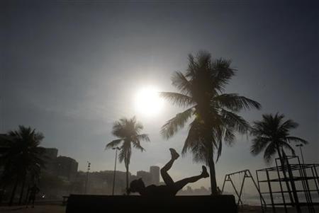 A woman exercises on Leblon beach in Rio de Janeiro A woman exercises on Leblon beach in Rio de Janeiro