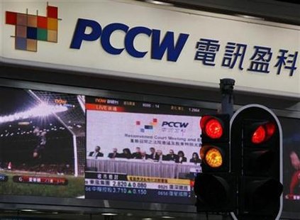 A screen broadcasts a live news feed of an extraordinary general meeting of PCCW outside a PCCW outlet in Hong Kong A screen broadcasts a live news feed of an extraordinary general meeting of PCCW outside a PCCW outlet in Hong Kong