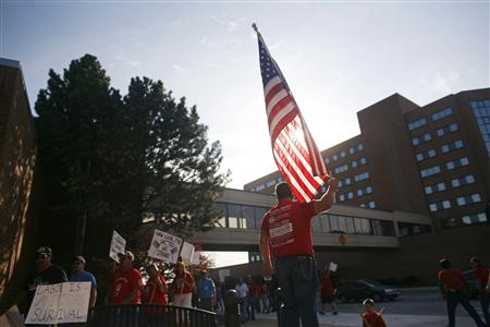 Members of the United Auto Workers march around the Oshkosh convention centre in protest against their employer Oshkosh Corp., in Oshkosh Members of the United Auto Workers march around the Oshkosh convention centre in protest against their employer Oshkosh Corp., in Oshkosh