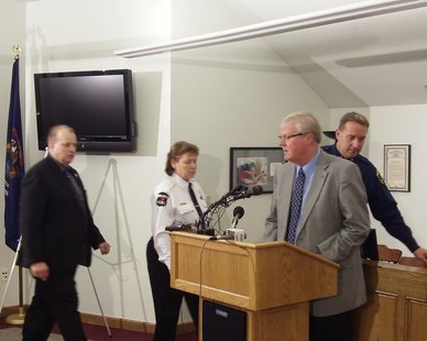 Ottawa Co. Sheriff Gary Rosema is about to address the media, while Michigan State Police Chief Inspector Dave Roeseler, Walker Police Chief Catherin Garcia-Lindsrom and Muskegon Co. Sheriff Dean Roesler (R to L) walk behind, during a Oct. 13, 2011 press briefing at Coopersville City Hall to describe the situation