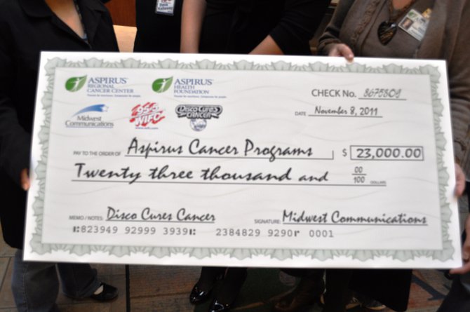WIFC presents a check for $23,000 to Aspirus Cancer Care.