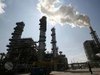 Smoke rises from a refinery