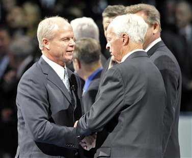 Hockey hall of Fame inductee MARk Howe shakes hands with his father Gordie Howe during on-ice ceremony before NHL hockey game between Toront Hockey hall of Fame inductee MARk Howe shakes hands with his father Gordie Howe during on-ice ceremony before NHL hockey game between Toront