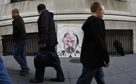 People pass Artist Geoffrey Raymond's latest painting "Corzine Agonistes" on Broad Street across from the New York Stock Exchange in New Yor People pass Artist Geoffrey Raymond's latest painting "Corzine Agonistes" on Broad Street across from the New York Stock Exchange in New Yor