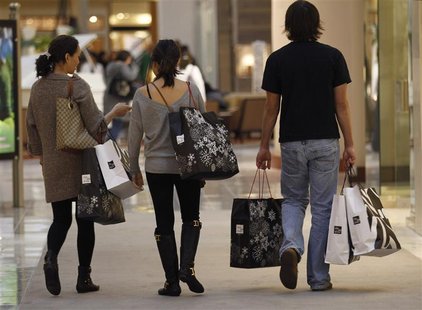 Shoppers carry their purchases during the Black Friday sales at a shopping mall in Tysons Corner Shoppers carry their purchases during the Black Friday sales at a shopping mall in Tysons Corner