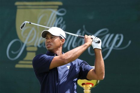 U.S. team member Woods has a practice swing on the first tee before his first round foursome match of the Presidents Cup in Melbourne U.S. team member Woods has a practice swing on the first tee before his first round foursome match of the Presidents Cup in Melbourne