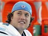 Detroit Lions quarterback Matthew Stafford smiles on the sidelines after being taken out late in their NFL footbal game against the Denver