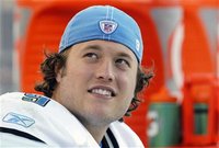 Detroit Lions quarterback Matthew Stafford smiles on the sidelines after being taken out late in their NFL footbal game against the Denver