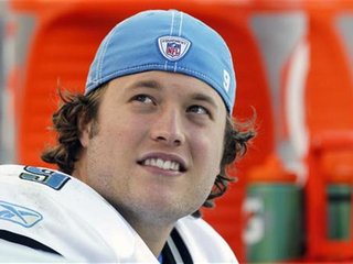 Detroit Lions quarterback Matthew Stafford smiles on the sidelines after being taken out late in their NFL footbal game against the Denver