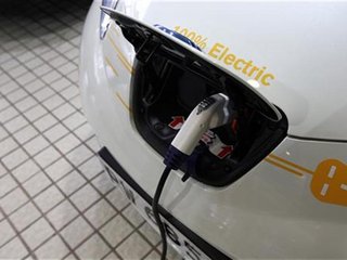 A Nissan Leaf electric car charges at the Dah Chong Hong showroom in Hong Kong