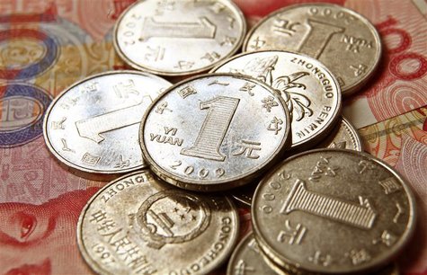 Chinese one yuan coins are placed on 100 yuan banknotes in this illustrative photograph taken in Beijing Chinese one yuan coins are placed on 100 yuan banknotes in this illustrative photograph taken in Beijing