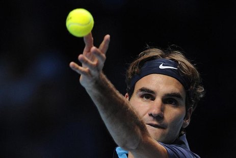 Federer of Switzerland serves to Tsonga of France during their singles tennis match at the ATP World Tour Finals in London Federer of Switzerland serves to Tsonga of France during their singles tennis match at the ATP World Tour Finals in London
