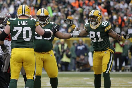 Green Bay Packers' B.J. Raji celebrates his touchdown with T.J. Lang and Andrew Quarless against the Tampa Bay Buccaneers during their NFL f Green Bay Packers' B.J. Raji celebrates his touchdown with T.J. Lang and Andrew Quarless against the Tampa Bay Buccaneers during their NFL f