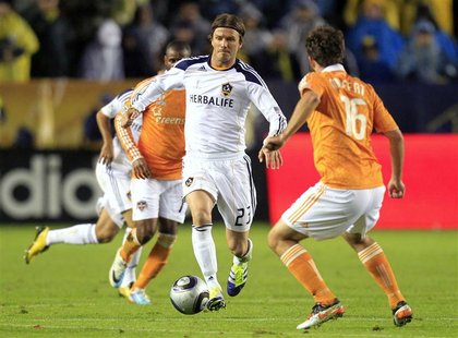 Los Angeles Galaxy midfielder Beckham dribbles the ball against the Houston Dynamo during the MLS Cup final in Carson Los Angeles Galaxy midfielder Beckham dribbles the ball against the Houston Dynamo during the MLS Cup final in Carson