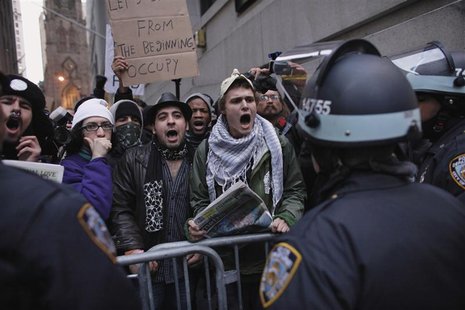 Protesters affiliated with the Occupy Wall Street movement shout slogans to police officers while they march to the New York Stock Exchange Protesters affiliated with the Occupy Wall Street movement shout slogans to police officers while they march to the New York Stock Exchange