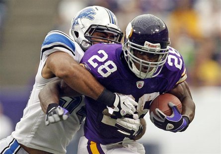 Minnesota Vikings running back Peterson is tackled by Detroit Lions line backer Levy during their NFC football game in Minneapolis Minnesota Vikings running back Peterson is tackled by Detroit Lions line backer Levy during their NFC football game in Minneapolis