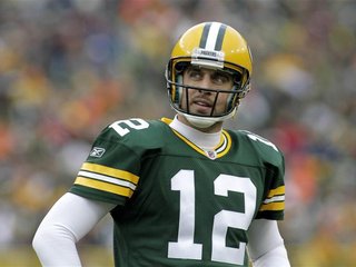 Green Bay Packers' Aaron Rodgers checks the clock against the Tampa Bay Buccaneers in the second half during their NFL football game in Gree