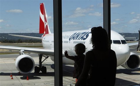 Stranded Qantas passengers look at a Qantas Airbus A330 plane as they wait for their flights at the departure gates of Perth Domestic Airpor Stranded Qantas passengers look at a Qantas Airbus A330 plane as they wait for their flights at the departure gates of Perth Domestic Airpor
