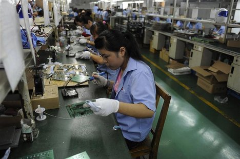 An employee works on circuit boards at an electronic component factory in Hefei An employee works on circuit boards at an electronic component factory in Hefei