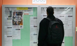 File photo of a man looking at employment opportunities at a jobs center in San Francisco