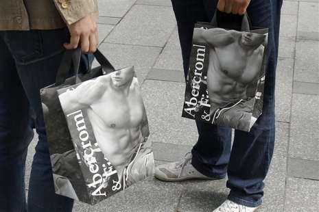Shoppers hold bags with clothing purchases on the opening day of operations by retailers Abercrombie & Fitch outside their Paris store Shoppers hold bags with clothing purchases on the opening day of operations by retailers Abercrombie & Fitch outside their Paris store
