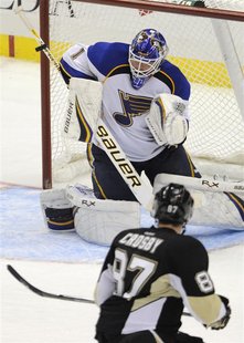 St. Louis Blues goalie Brian Elliott makes a stick save against the Pittsburgh Penguins Sidney Crosby in their NHL hockey game in Pittsburgh St. Louis Blues goalie Brian Elliott makes a stick save against the Pittsburgh Penguins Sidney Crosby in their NHL hockey game in Pittsburgh