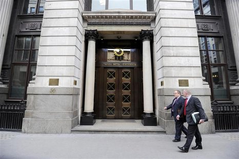Men walk past the London Metal Exchange (LME) in London Men walk past the London Metal Exchange (LME) in London