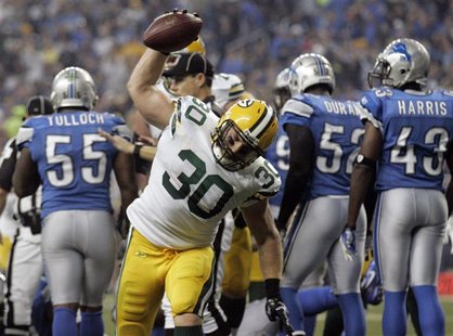 Green Bay Packers full back John Kuhn spikes the ball after scoring a touch down against the Detroit Lions during the second half of their N Green Bay Packers full back John Kuhn spikes the ball after scoring a touch down against the Detroit Lions during the second half of their N