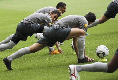 Brazil's Neymar stretches with team mates during a national soccer team training session in Stuttgart Brazil's Neymar stretches with team mates during a national soccer team training session in Stuttgart
