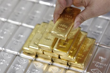 An employee picks up a gold bar at the Austrian Gold and Silver Separating Plant 'Oegussa' in Vienna An employee picks up a gold bar at the Austrian Gold and Silver Separating Plant 'Oegussa' in Vienna
