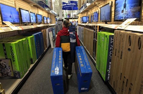 A shopper drags boxes of televisions through the aisles at Best Buy on the shopping day dubbed "Black Friday" in Framingham A shopper drags boxes of televisions through the aisles at Best Buy on the shopping day dubbed "Black Friday" in Framingham
