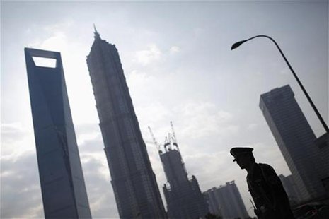 A security guard stands in the financial district of Pudong in Shanghai A security guard stands in the financial district of Pudong in Shanghai