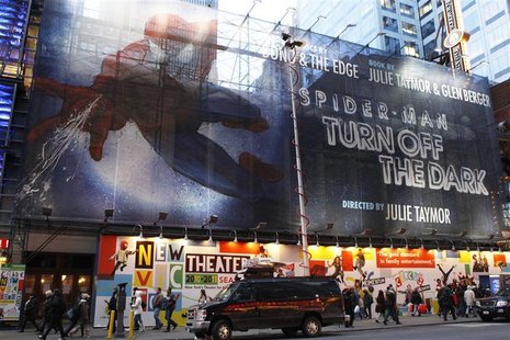 Pedestrians walk underneath a banner advertising the Broadway play "Spiderman: Turn Off The Dark" in New York Pedestrians walk underneath a banner advertising the Broadway play "Spiderman: Turn Off The Dark" in New York