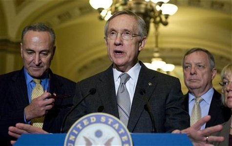 Reid stands with Schumer and Durbin as he talks to reporters about the senate's vote on debt ceiling legislation at the U.S. Capitol in Wash