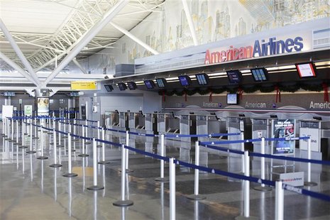 An American Airlines counter stands empty at John F Kennedy International Airport in New York An American Airlines counter stands empty at John F Kennedy International Airport in New York