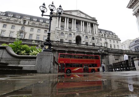 A double decker bus is reflected in a puddle after a rain shower outside the Bank of England in the City of London A double decker bus is reflected in a puddle after a rain shower outside the Bank of England in the City of London
