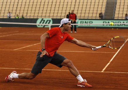 Spain's Rafael Nadal returns a ball during a training session for the upcoming Davis Cup final in Seville Spain's Rafael Nadal returns a ball during a training session for the upcoming Davis Cup final in Seville