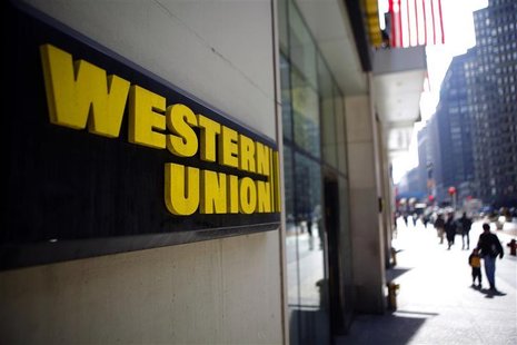 People walk outside a Western Union branch in New York People walk outside a Western Union branch in New York