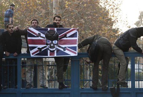 Iranian protesters climb over the gate of the British embassy in Tehran. Iranian protesters climb over the gate of the British embassy in Tehran.