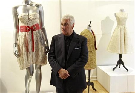Mitch Winehouse, the father of deceased British singer Amy Winehouse, poses for photographers next to the "Back to Black" album-cover dress Mitch Winehouse, the father of deceased British singer Amy Winehouse, poses for photographers next to the "Back to Black" album-cover dress