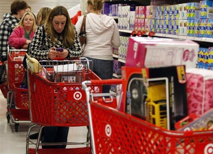 A woman uses her smartphone as she waits in line to checkout at a Target store on the shopping day dubbed "Black Friday" in Torrington A woman uses her smartphone as she waits in line to checkout at a Target store on the shopping day dubbed "Black Friday" in Torrington
