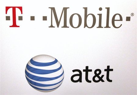 AT & T and T-Mobile logos are seen posted on the wall of a subway station at West 14th street and 8th avenue in New York AT & T and T-Mobile logos are seen posted on the wall of a subway station at West 14th street and 8th avenue in New York