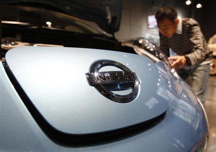 A visitor looks at Nissan Motor's electric car Leaf at the company's showroom in Tokyo A visitor looks at Nissan Motor's electric car Leaf at the company's showroom in Tokyo
