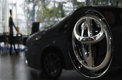 A visitor is reflected on a Toyota car at the company's showroom in Tokyo A visitor is reflected on a Toyota car at the company's showroom in Tokyo
