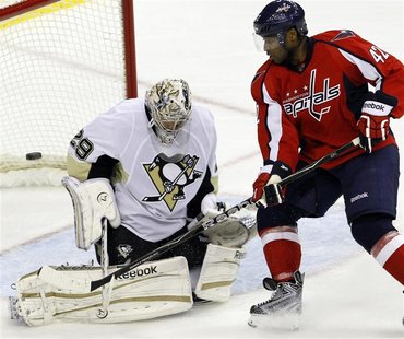 Pittsburgh Penguins Marc-Andre Fleury deflects a shot by Washington Capitals Joel Ward during their NHL hockey game in Washington Pittsburgh Penguins Marc-Andre Fleury deflects a shot by Washington Capitals Joel Ward during their NHL hockey game in Washington