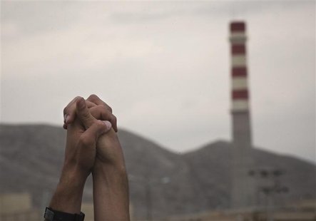 Iranian students hold up their hands as a sign of unity as they form a human chain around the Uranium Conversion Facility (UCF) to show thei Iranian students hold up their hands as a sign of unity as they form a human chain around the Uranium Conversion Facility (UCF) to show thei