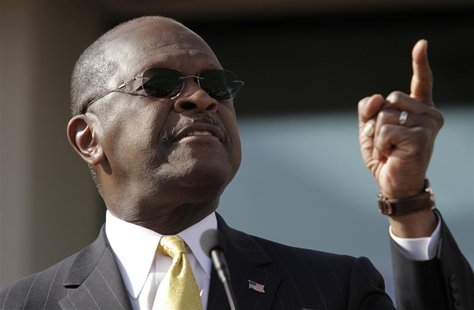 Herman Cain gestures as he announces that he is "suspending" his Republican presidential campaign at his Georgia campaign headquarters in At