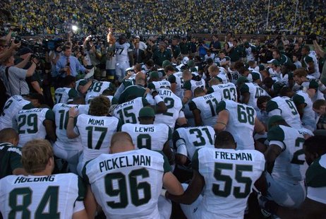 Michigan State Football prays following their 2010 victory over Michigan. Michigan State Football prays following their 2010 victory over Michigan.