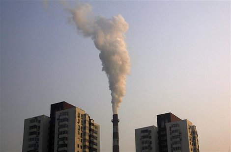 A chimney of a coal burning heating system for apartment blocks billows smoke in central Beijing A chimney of a coal burning heating system for apartment blocks billows smoke in central Beijing